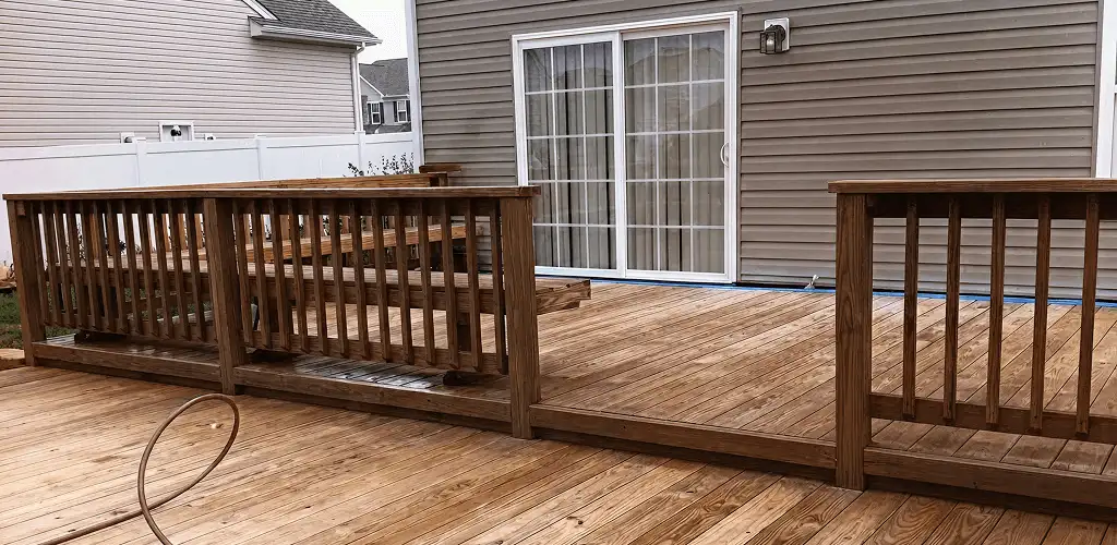 Deck sealing service protecting a backyard wood deck and railings in Erie, PA