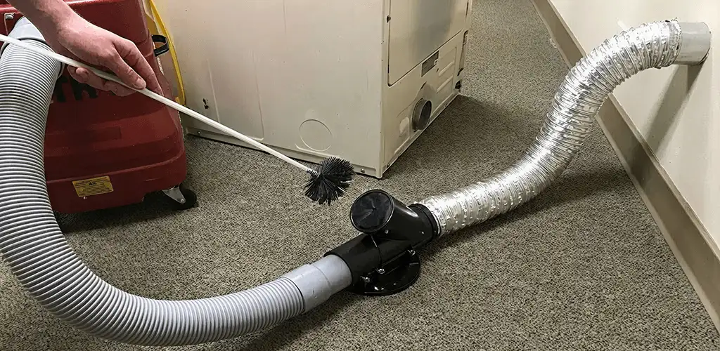 Dryer vent cleaning service removing lint from a dryer duct connection in Erie, PA