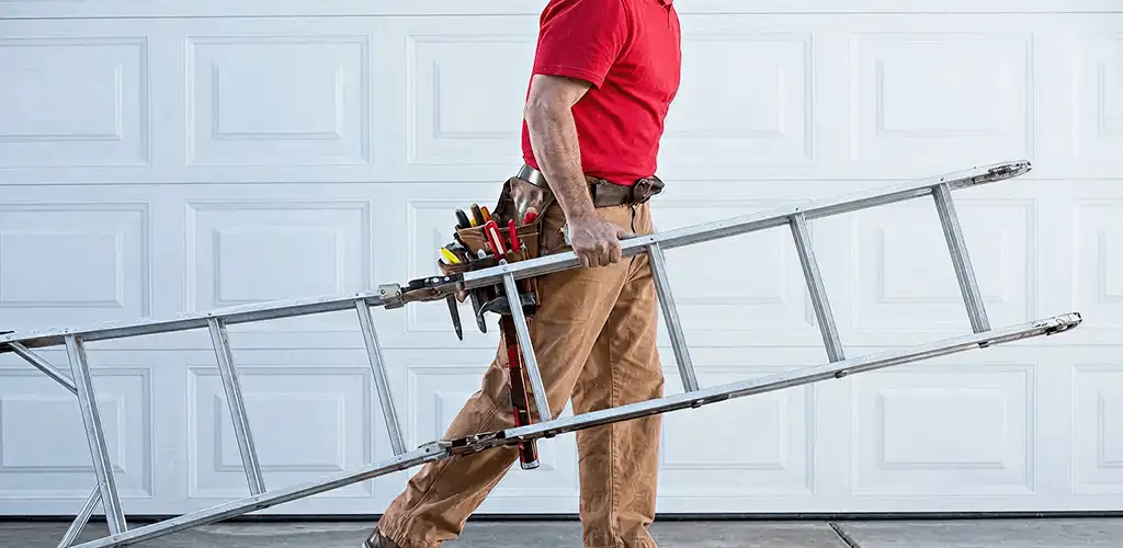 Garage door repair technician arriving with tools and ladder in Erie, PA