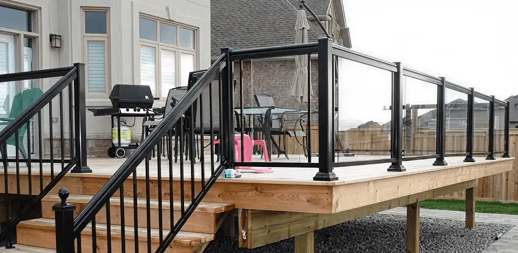 Handrail installation on a deck staircase for safety and code compliance in Erie, PA