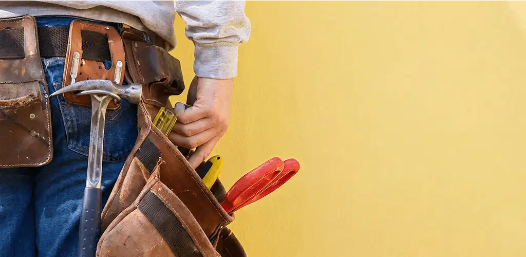 Handyman with tool belt ready for home repairs and maintenance in Erie, PA