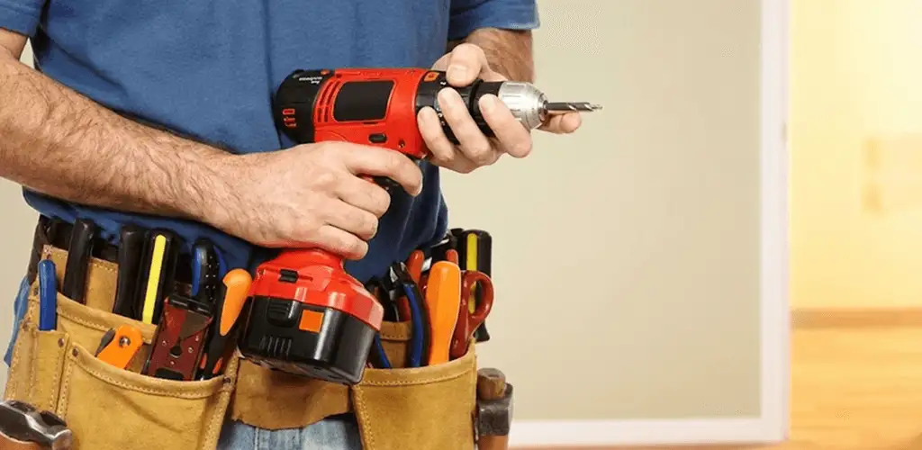 Handyman holding a power drill for home repairs and installations in Erie, PA