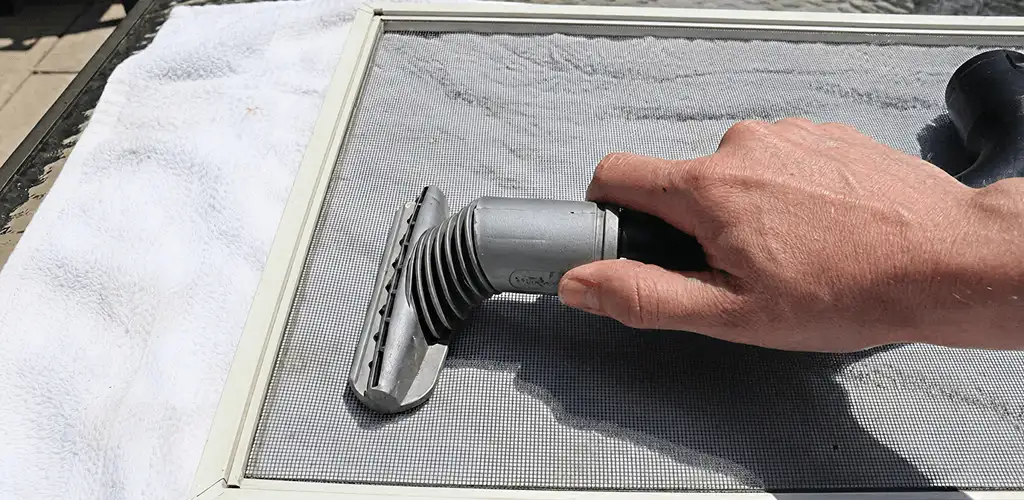 Window screen repair cleaning and fixing a damaged screen mesh in Erie, PA