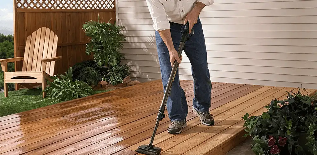 Deck staining service applying stain to a backyard wood deck in Erie, PA